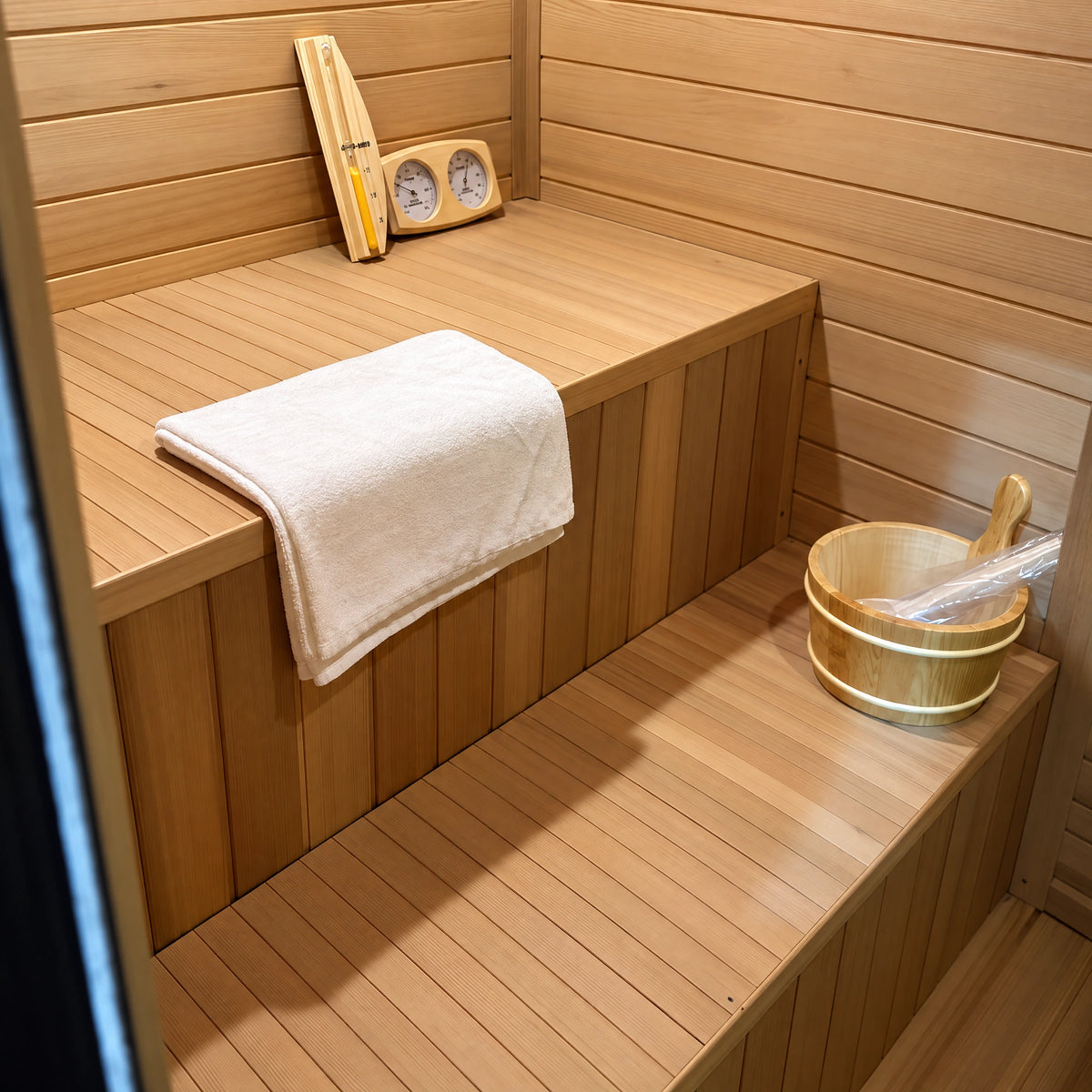 Two levels of timber seating with closed vertical bench fronts.