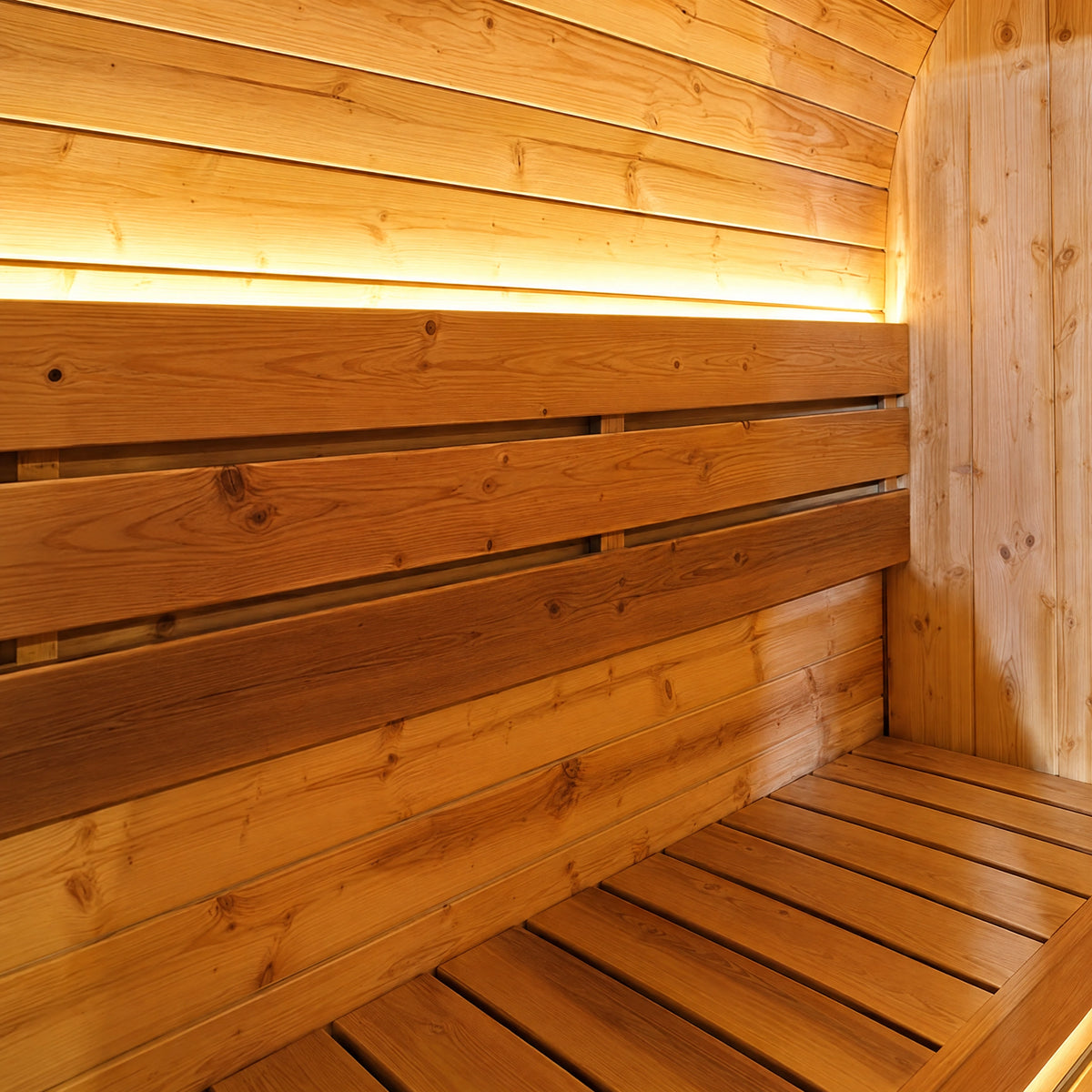 Close view of a slatted side bench and timber backrest under the sauna’s warm light band.