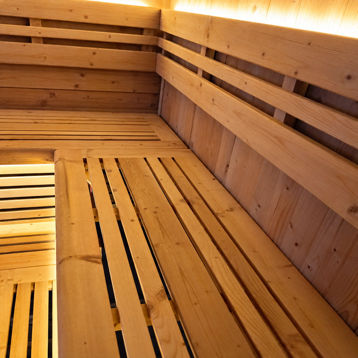 Close view of the slatted timber bench corner and backrest inside the sauna.