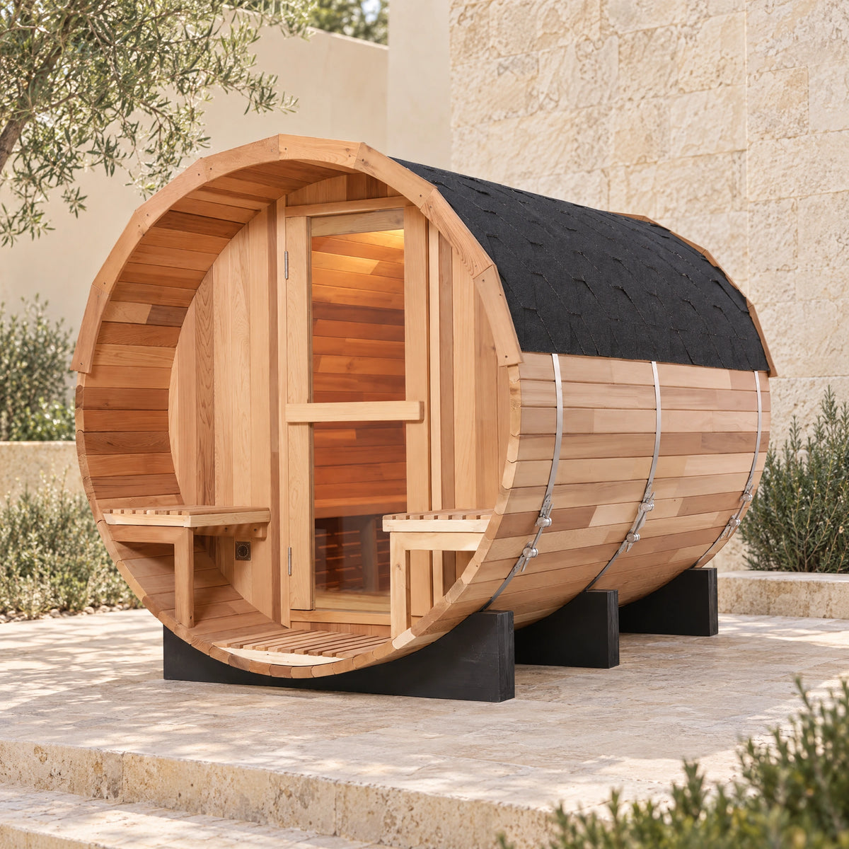 Daylight main view of the red cedar barrel sauna with its closed glass door and recessed porch.