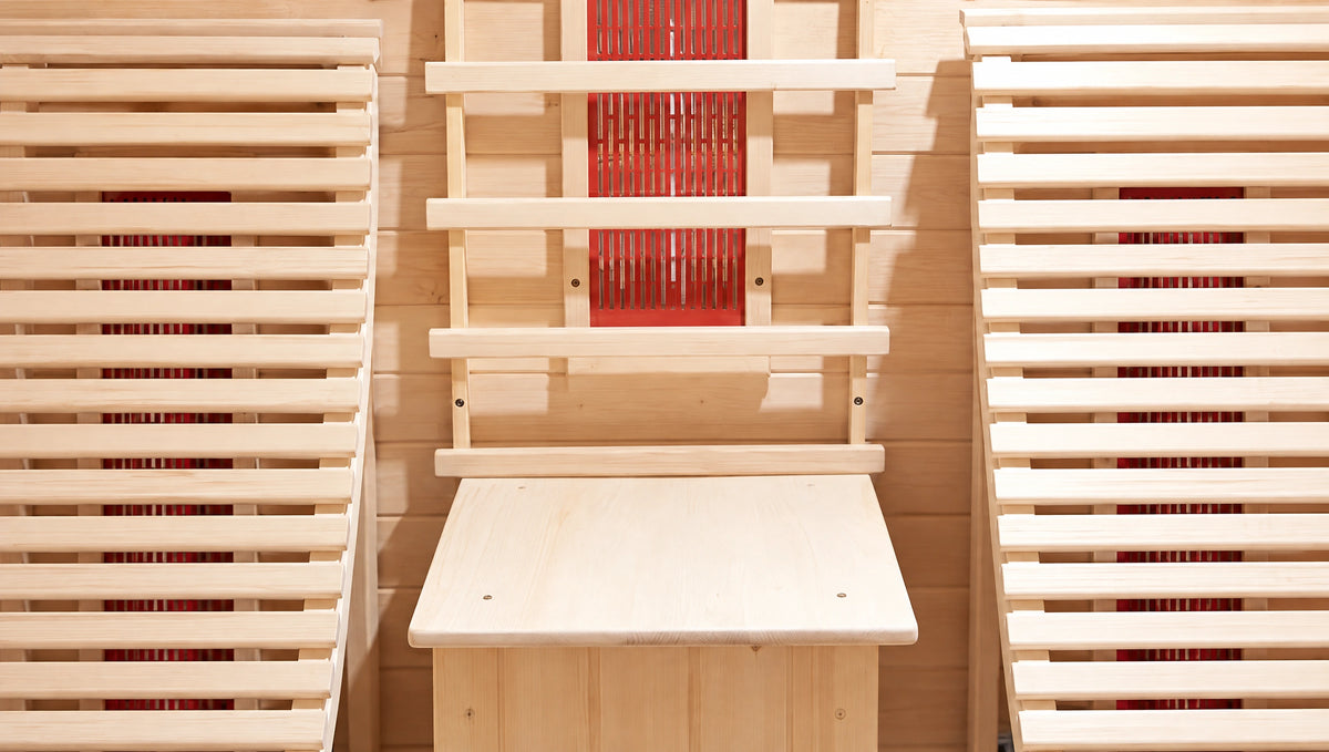 Wide material detail of pale timber seat slats beside the central guard and pedestal.